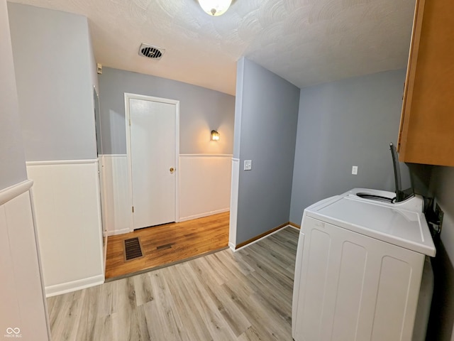771 Doran Ave, Shelbyville, IN 46176 - laundry area featuring washer / clothes dryer, cabinet space, light wood finished floors, and a textured ceiling