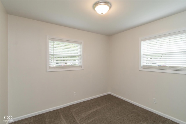717 Berkeley Dr, Shelbyville, IN 46176 - spare room featuring dark colored carpet and baseboards