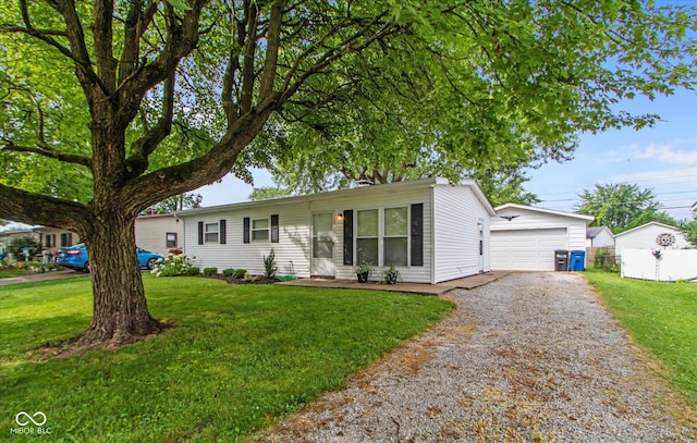 717 Berkeley Dr, Shelbyville, IN 46176 - single story home with an outbuilding, a front lawn, and a garage