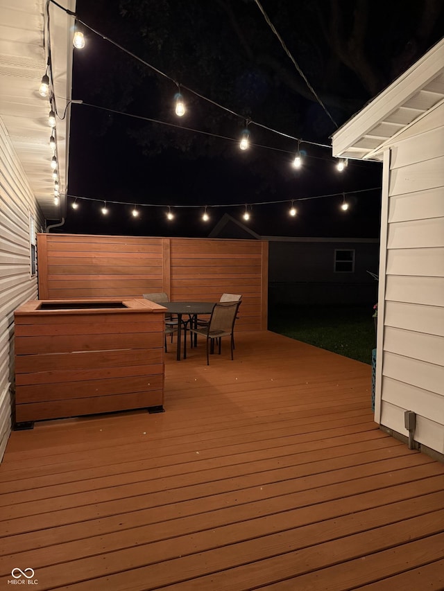 717 Berkeley Dr, Shelbyville, IN 46176 - deck at night featuring outdoor dining area