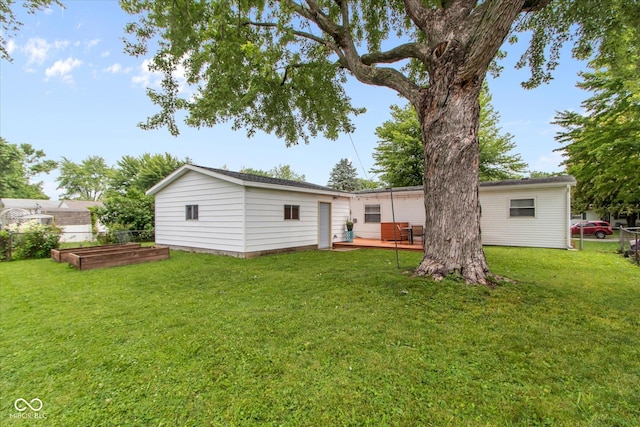 717 Berkeley Dr, Shelbyville, IN 46176 - back of property featuring a vegetable garden, a deck, and an outdoor structure