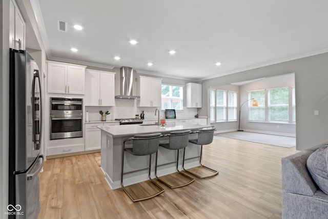 15546 Senita Ln, Fishers, IN 46037 - kitchen with appliances with stainless steel finishes, wall chimney range hood, open floor plan, crown molding, and decorative backsplash