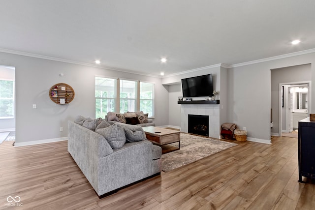 15546 Senita Ln, Fishers, IN 46037 - living room with light wood-style floors, a tiled fireplace, crown molding, and recessed lighting