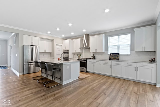 15546 Senita Ln, Fishers, IN 46037 - kitchen with appliances with stainless steel finishes, wall chimney range hood, crown molding, backsplash, and a breakfast bar