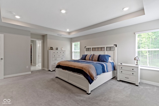 15546 Senita Ln, Fishers, IN 46037 - bedroom featuring light colored carpet, a raised ceiling, multiple windows, and recessed lighting