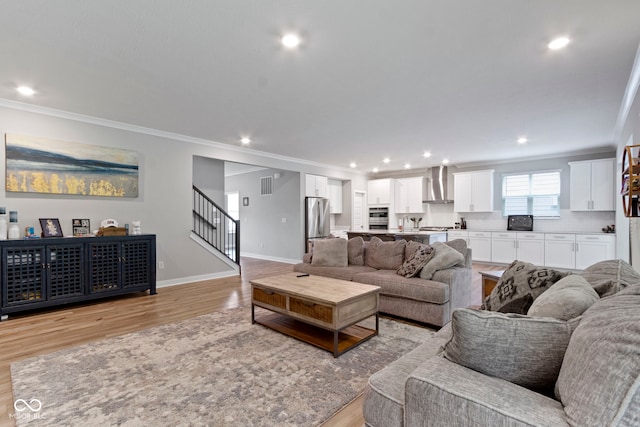 15546 Senita Ln, Fishers, IN 46037 - living room with crown molding, light wood-style flooring, stairway, and recessed lighting