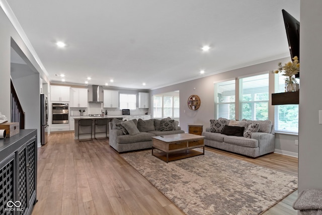 15546 Senita Ln, Fishers, IN 46037 - living area with ornamental molding, light wood finished floors, and recessed lighting
