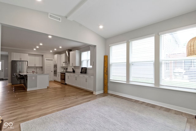 15546 Senita Ln, Fishers, IN 46037 - kitchen featuring appliances with stainless steel finishes, white cabinets, wall chimney range hood, decorative backsplash, and recessed lighting
