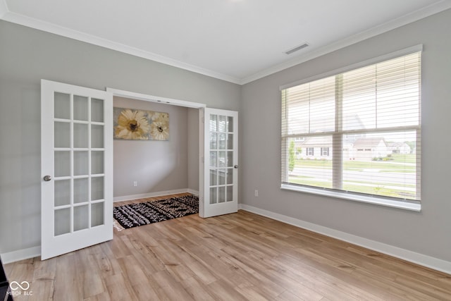 15546 Senita Ln, Fishers, IN 46037 - spare room featuring french doors, ornamental molding, and light wood finished floors