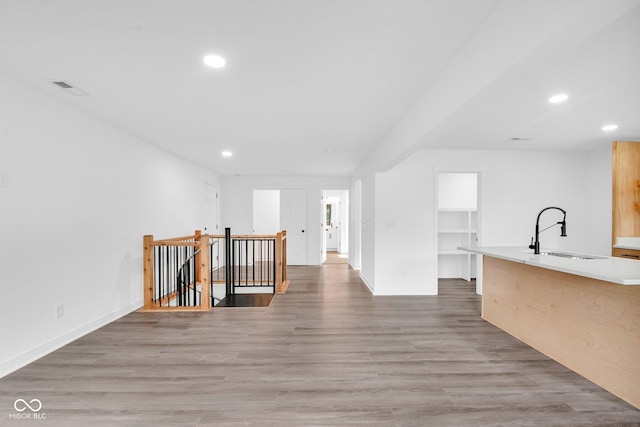 1555 N Dearborn St, Indianapolis, IN 46201 - kitchen featuring recessed lighting, light wood-style flooring, light countertops, and a center island with sink