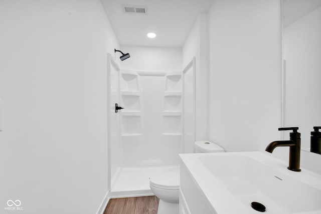 1555 N Dearborn St, Indianapolis, IN 46201 - bathroom featuring a shower stall, wood finished floors, and vanity