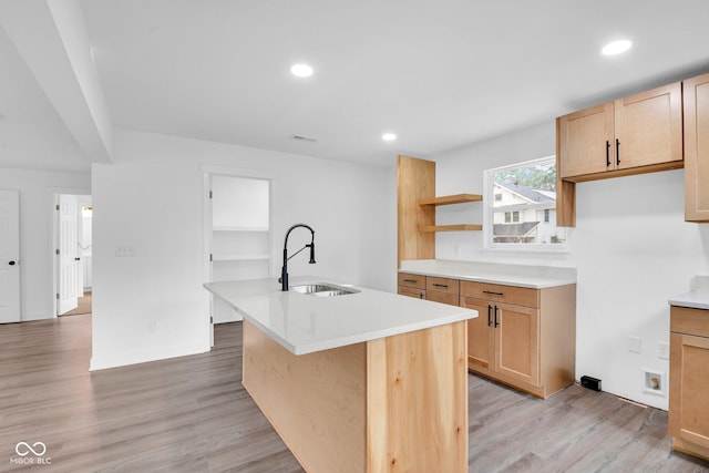 1555 N Dearborn St, Indianapolis, IN 46201 - kitchen with open shelves, a kitchen island with sink, light wood-style flooring, light countertops, and recessed lighting