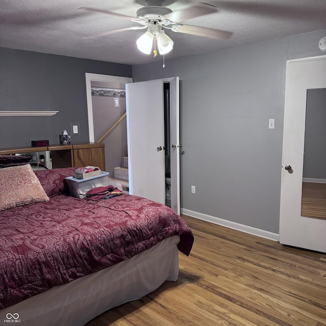 206 W 2nd St, Greensburg, IN 47240 - bedroom featuring wood finished floors, a ceiling fan, and a textured ceiling