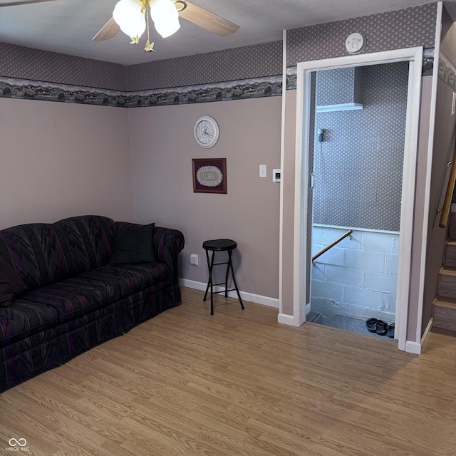 206 W 2nd St, Greensburg, IN 47240 - living area with light wood-style flooring, wallpapered walls, and a ceiling fan