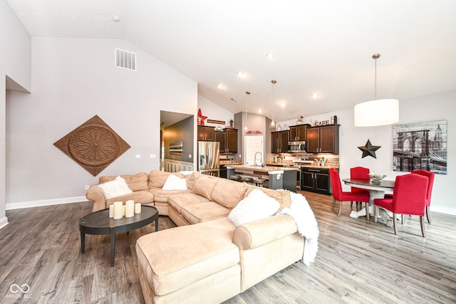 561 Farnham Dr, Westfield, IN 46074 - living room featuring light wood finished floors, high vaulted ceiling, and recessed lighting