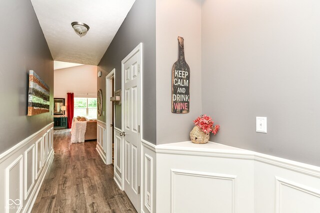 561 Farnham Dr, Westfield, IN 46074 - hallway featuring wood finished floors, a wainscoted wall, lofted ceiling, and a decorative wall