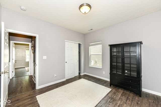 561 Farnham Dr, Westfield, IN 46074 - unfurnished bedroom with multiple windows, dark wood-style floors, and a closet