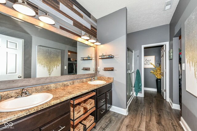 561 Farnham Dr, Westfield, IN 46074 - bathroom featuring wood finished floors, a stall shower, and double vanity