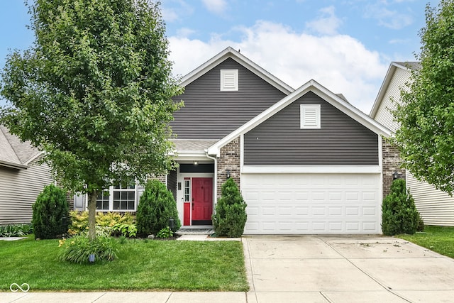 561 Farnham Dr, Westfield, IN 46074 - traditional home with concrete driveway, a front lawn, a garage, and brick siding