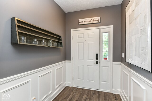 561 Farnham Dr, Westfield, IN 46074 - entryway with a wainscoted wall, a decorative wall, dark wood-type flooring, and a textured ceiling