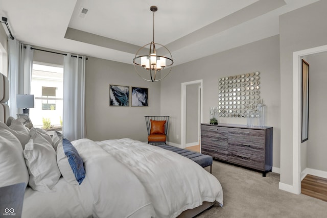 17030 Daly Dr, Noblesville, IN 46062 - bedroom featuring a chandelier, a raised ceiling, and light colored carpet