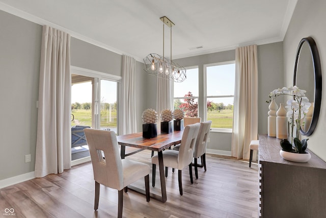 17030 Daly Dr, Noblesville, IN 46062 - dining area with plenty of natural light, a chandelier, crown molding, and light wood-style flooring