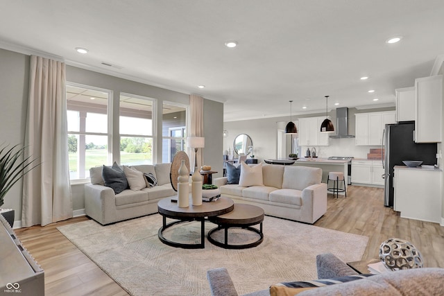 17030 Daly Dr, Noblesville, IN 46062 - living room featuring light wood-style flooring, ornamental molding, and recessed lighting