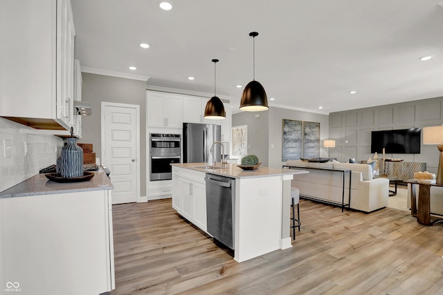 17030 Daly Dr, Noblesville, IN 46062 - kitchen featuring stainless steel appliances, crown molding, light wood-style floors, white cabinets, and recessed lighting