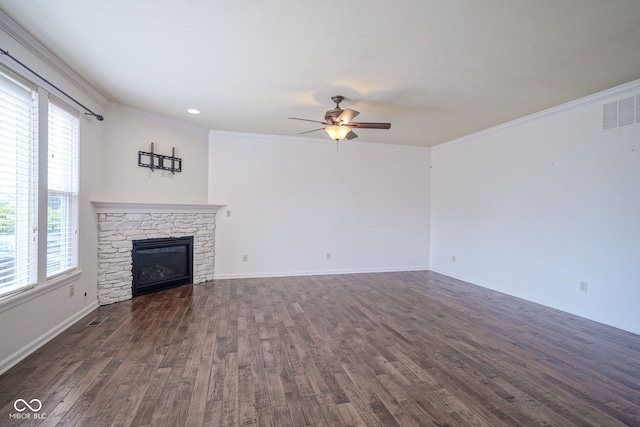 6471 W Clearview Dr, Mccordsville, IN 46055 - unfurnished living room with a ceiling fan, plenty of natural light, dark wood-style floors, a stone fireplace, and crown molding