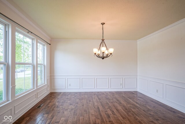 6471 W Clearview Dr, Mccordsville, IN 46055 - empty room featuring plenty of natural light, a chandelier, dark wood-style flooring, wainscoting, and a decorative wall