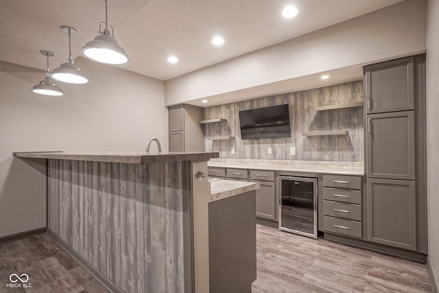 6471 W Clearview Dr, Mccordsville, IN 46055 - kitchen with beverage cooler, gray cabinets, open shelves, backsplash, and light wood-style flooring