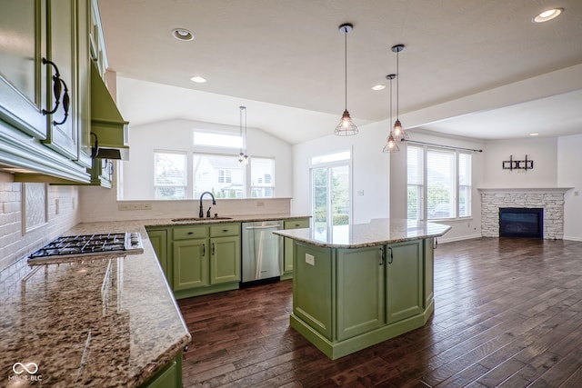 6471 W Clearview Dr, Mccordsville, IN 46055 - kitchen with green cabinets, stainless steel appliances, a fireplace, dark wood-style floors, and decorative backsplash