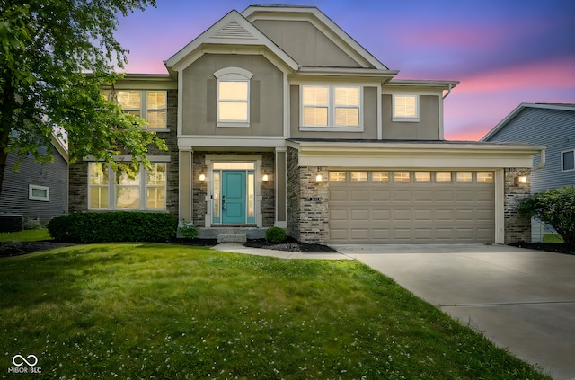 6471 W Clearview Dr, Mccordsville, IN 46055 - traditional-style house with stucco siding, concrete driveway, a yard, and stone siding