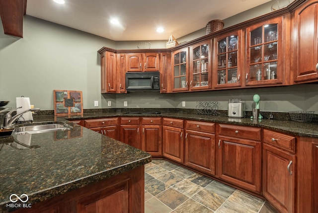 3104 E Chase Ln E, Bloomington, IN 47401 - kitchen with black microwave, glass insert cabinets, recessed lighting, and dark stone counters