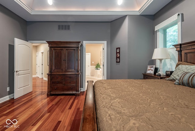 3104 E Chase Ln E, Bloomington, IN 47401 - bedroom featuring wood finished floors, a tray ceiling, ornamental molding, and connected bathroom