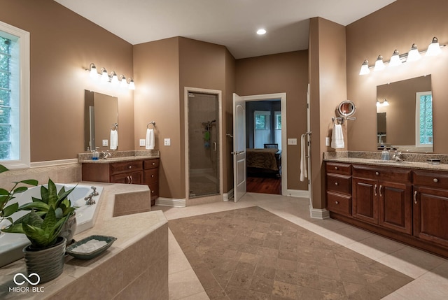 3104 E Chase Ln E, Bloomington, IN 47401 - full bath featuring two vanities, a bath, a stall shower, tile patterned flooring, and recessed lighting