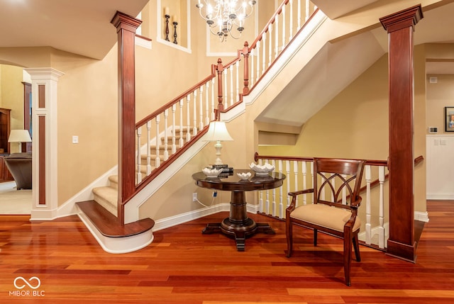 3104 E Chase Ln E, Bloomington, IN 47401 - stairs featuring decorative columns, wood finished floors, and a chandelier