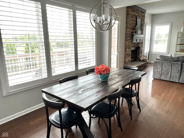 13895 Cloverfield Cir, Fishers, IN 46038 - dining space featuring a chandelier, a stone fireplace, and wood finished floors