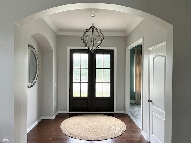 13895 Cloverfield Cir, Fishers, IN 46038 - foyer entrance with dark wood finished floors, a chandelier, ornamental molding, french doors, and arched walkways