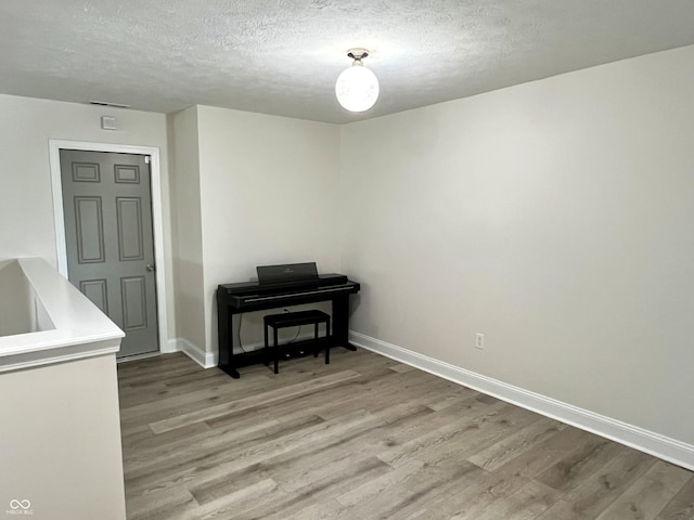 13895 Cloverfield Cir, Fishers, IN 46038 - dining room with light wood-style flooring and a textured ceiling