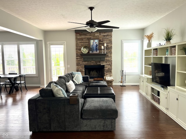 13895 Cloverfield Cir, Fishers, IN 46038 - living room with a textured ceiling, ceiling fan, dark wood-style floors, plenty of natural light, and a fireplace