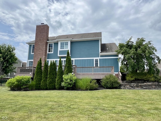 13895 Cloverfield Cir, Fishers, IN 46038 - back of house featuring a chimney, a yard, a wooden deck, and roof with shingles