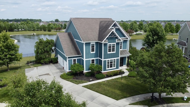 13895 Cloverfield Cir, Fishers, IN 46038 - view of front facade with concrete driveway, a water view, roof with shingles, a standing seam roof, and board and batten siding