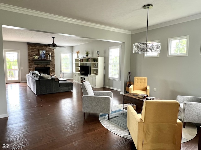 13895 Cloverfield Cir, Fishers, IN 46038 - living area with dark wood-style floors, plenty of natural light, a stone fireplace, a ceiling fan, and ornamental molding