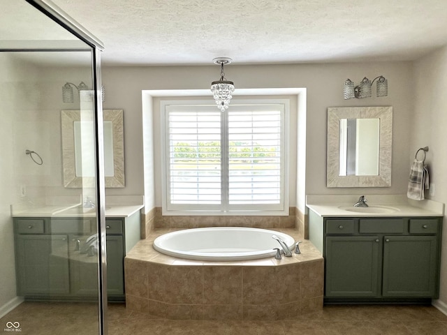 13895 Cloverfield Cir, Fishers, IN 46038 - full bath with two vanities, a garden tub, a textured ceiling, and tile patterned flooring
