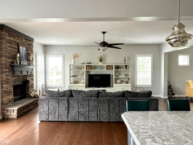 13895 Cloverfield Cir, Fishers, IN 46038 - living area featuring ceiling fan, dark wood-style flooring, and a fireplace