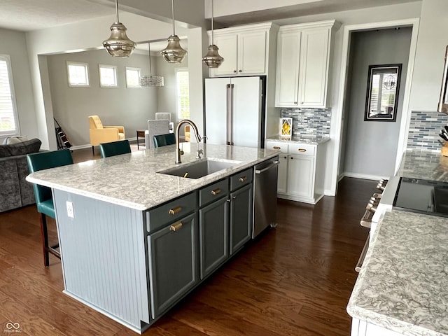 13895 Cloverfield Cir, Fishers, IN 46038 - kitchen with appliances with stainless steel finishes, a breakfast bar, decorative backsplash, and white cabinets