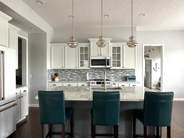 13895 Cloverfield Cir, Fishers, IN 46038 - kitchen with decorative backsplash, dark wood-style floors, refrigerator, light stone countertops, and recessed lighting