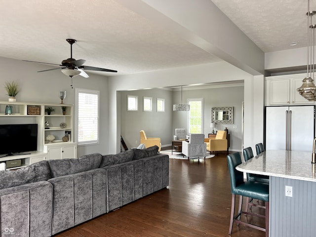 13895 Cloverfield Cir, Fishers, IN 46038 - living room featuring a ceiling fan, a textured ceiling, and dark wood-style flooring