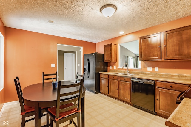 3872 Dusty Sands Rd, Whitestown, IN 46075 - kitchen with black appliances, light flooring, light countertops, brown cabinets, and a textured ceiling
